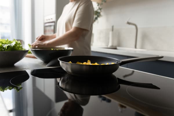 A wide shot of an induction surface with a pan - iStock Credit: fizkes